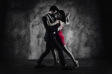 Poster - Full size body portrait of lovely attractive couple standing close in tango position face to face dancing, charming lady in purple tight dress gentlemen in tux isolated on grey background movement