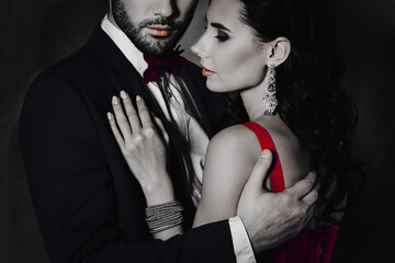 Poster - Cropped close up portrait of lovely attractive couple embracing, pretty charming mrs with jewelry, rich half face mr with stubble isolated on grey background