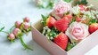 © Nuttaya Nampai - Luxurious presentation of a box containing glossy strawberries and romantic flowers, shot on a smooth light background.
