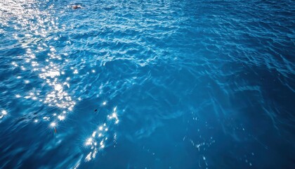 Poster - tranquil turquoise ocean surface with sunlit ripples, ideal for travel marketing, design background, or nature inspired projects

