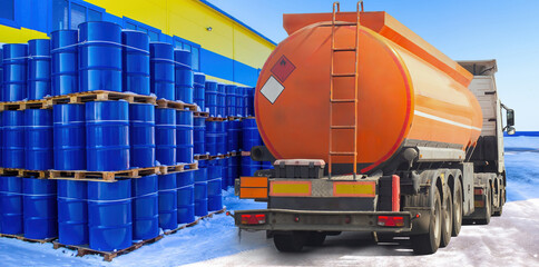 Poster - Fuel truck on territory warehouse. Barrels gasoline near industrial building. Fuel truck for oil delivery. Lorry with tank for transporting gasoline. Road transportation fuel products in winter day