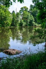 Wall Mural - A large rock sits in the middle of a pond