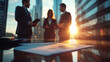 © Kornwit - Business meeting at sunset in skyscraper cityscape professional discussion urban environment focused viewpoint