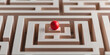 © A2Z AI  - A red sphere rests at the entrance of a complex wooden maze, symbolizing the challenges and decisions faced in navigating a difficult path.