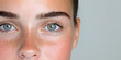 © A2Z AI  - Close-up of a woman's face, showcasing her clear skin, freckles, and blue eyes.