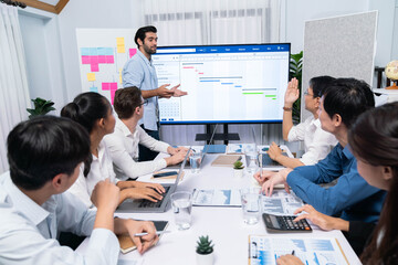 Leinwandbilder - Project manager communicate and collaborate with team using project management software display on monitor, tracking progress of project task and making schedule plan at meeting table. Prudent