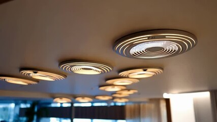 Aufkleber - Circular led ceiling lights gradually illuminating, creating sophisticated ambient lighting within contemporary hotel lobby, highlighting modern architectural design and innovative interior styling