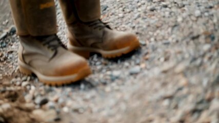 Aufkleber - Construction worker wearing robust leather safety boots standing securely on textured gravel surface, highlighting protective workwear and industrial job site stability