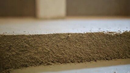 Aufkleber - Wet concrete mixture is extruded and shaped, forming a stair step, showcasing the layer by layer construction process and the material's texture