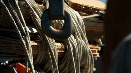 Aufkleber - Construction crane carefully lifting bundled building materials, securely fastened with ropes and prepared for precise placement at active construction site