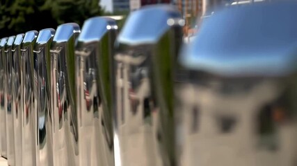 Aufkleber - Smooth, metallic surfaces of sound barriers reflect the surrounding environment, creating a visually appealing interplay of light and reflections