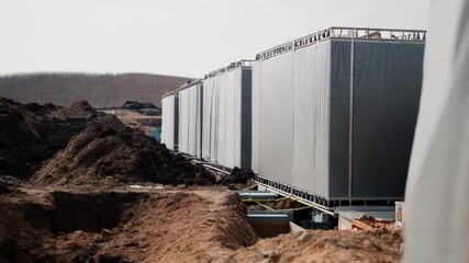 Aufkleber - Prefabricated building modules getting assembled by construction workers at large industrial site, highlighting streamlined construction techniques and modern engineering efficiency