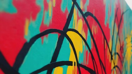 Aufkleber - Vibrant street art showcasing an abstract design with bold splashes of red, yellow, and teal on a construction barrier adds a pop of color to an urban environment