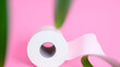 © Nicholas - White toilet paper roll on isolated pink background. Personal hygiene.