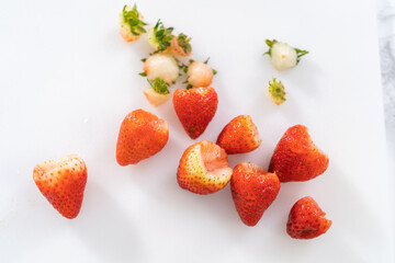 Wall Mural - Fresh Strawberries Displayed on a White Cutting Board