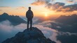 © Jittapon - Silhouetted hiker standing atop a rugged mountain peak gazing out at the vast awe inspiring landscape as the sun sets contemplating their strategic vision and bold ambitions for the future