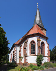 Wall Mural - Medieval church with bell tower and gothic apse in the old village of Freckenfeld, Rheinland-Pfalz region in Germany