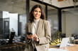 © Stock 4 You - Young Indian business woman manager ceo using cell phone mobile app laptop. Smiling Latin Hispanic mature female businesswoman holding smartphone in office trading, reading, working online. Copy space