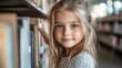 © aritha - Adorable girl with blue eyes looking at books in library.