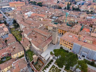 Aerial view of Rieti's historic old town in Italy, with the cathedral Santa Maria Assunta standing prominently in the center. Narrow medieval streets and terracotta rooftops surround the cathedral