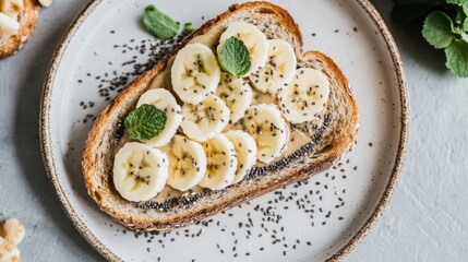 Poster - A beautifully styled shot of toasted bread with a spread of almond butter, topped with sliced bananas and chia seeds, arranged on a white plate with soft natural lighting.