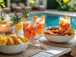 © Vadym - Festive poolside table with refreshing cocktails, fruit. Drinks colourful, vibrant. Fresh fruit salad, lemon, fruits on table. Relaxation, enjoyment central themes. Stylish casual get-away event