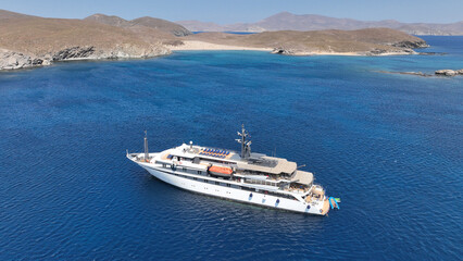 Wall Mural - Aerial drone photo of luxury yacht anchored in tropical exotic island bay with emerald sea and secluded sandy beaches