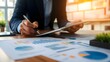 © Harry - Close-up of Businessperson Analyzing Financial Charts and Graphs on Tablet, Reviewing Data, Strategic Planning, Market Research, Modern Office