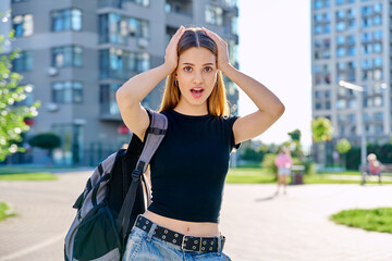 Wall Mural - Surprised teenage girl student with backpack outdoor