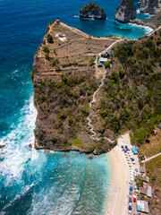 Canvas Print - Aerial shot of a secluded tropical beach next to crashing ocean waves (Atuh Beach, Nusa Penida)