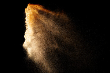 Wall Mural - Sand flying explosion isolated on black background ,throwing freeze stop motion object design.