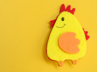 Easter one chicken handmade on yellow background, DIY concept, copy space, flat lay, easter concept