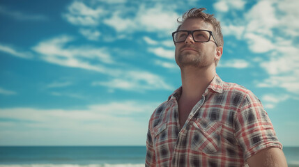 Wall Mural - European man with glasses against ocean backdrop. Ideal for coastal lifestyle, outdoor leisure, or personal reflection content.