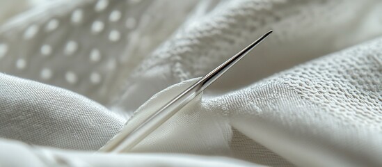 Sticker - Close-up of a needle piercing white fabric with textured patterns.