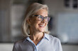 © fizkes - Head shot profile picture happy middle-aged businesswoman dressed in casual shirt, wear eyeglasses smiling looking aside, feel satisfied with promotion, professional achievements. Aspirations, career
