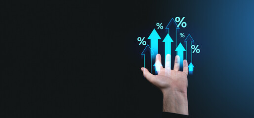 Poster - Hand holding glowing upward arrows and percentage symbols on dark gradient background. Concept of growth, success, and financial evolution.