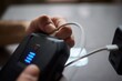 © Евгений Вершинин - Charging a portable power bank using a USB cable is a convenient and essential process