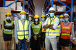 © iammotos - Portrait confident group of asian warehouse workers team wear mask standing and arms crossed in large factory warehouse looking at camera