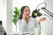 © Pormezz - content creator occupation concept. Woman record audio in-home office by condenser microphone