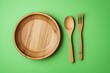 © Beautiful Stock  - Eco-friendly bamboo plate with spoon and fork on a vibrant green background.