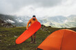 © EVERST - Man mountaineering with camping gear tent and sleeping pad - travel solo adventure healthy lifestyle summer active vacations trip survival climbing equipment
