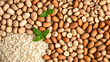 © Konstantin - Top view of peanuts, oats, soybeans and almonds arranged in horizontal rows.  sprigs of mint and lime Colorful display of healthy food ingredients.