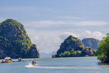 Wall Mural - A distant natural background of a large mountain in the middle of the sea, Phang Nga Bay, Thailand, from a major viewpoint where tourists come to watch the sunrise in the morning.