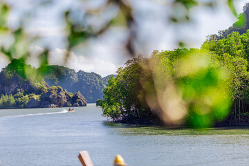 Wall Mural - A distant natural background of a large mountain in the middle of the sea, Phang Nga Bay, Thailand, from a major viewpoint where tourists come to watch the sunrise in the morning.