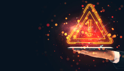 Aufkleber - Neon glowing warning triangle with exclamation mark over tablet in a hand, dark background with floating particles.