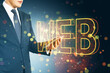 © Who is Danny - Businessman holding a tablet with glowing 'WEB' text surrounded by colorful bokeh lights on a dark background.