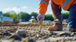 © keshia - A close-up of a civil engineer examining soil samples at a road construction site, Civil engineering scene, Geotechnical analysis style