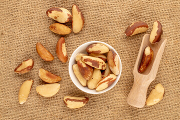 Wall Mural - Brazil nuts without shells  on jute cloth, close-up, top view.