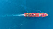 © boygek - Top view Cargo Container ship with contrail in the ocean ship carrying container and running for import export concept technology freight shipping by ship.