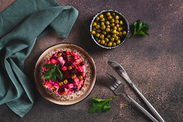 Wall Mural - Traditional beetroot salad with boiled vegetables and pickles on a plate on the table top view